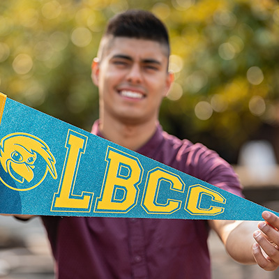 Student holding LBCC flag